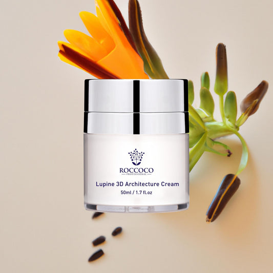 White jar of Roccoco Botanicals Lupine 3D Architecture Cream moisturizer on a tan background with botanical ingredients